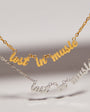 Two necklaces with 'lost in music' text on a neutral background