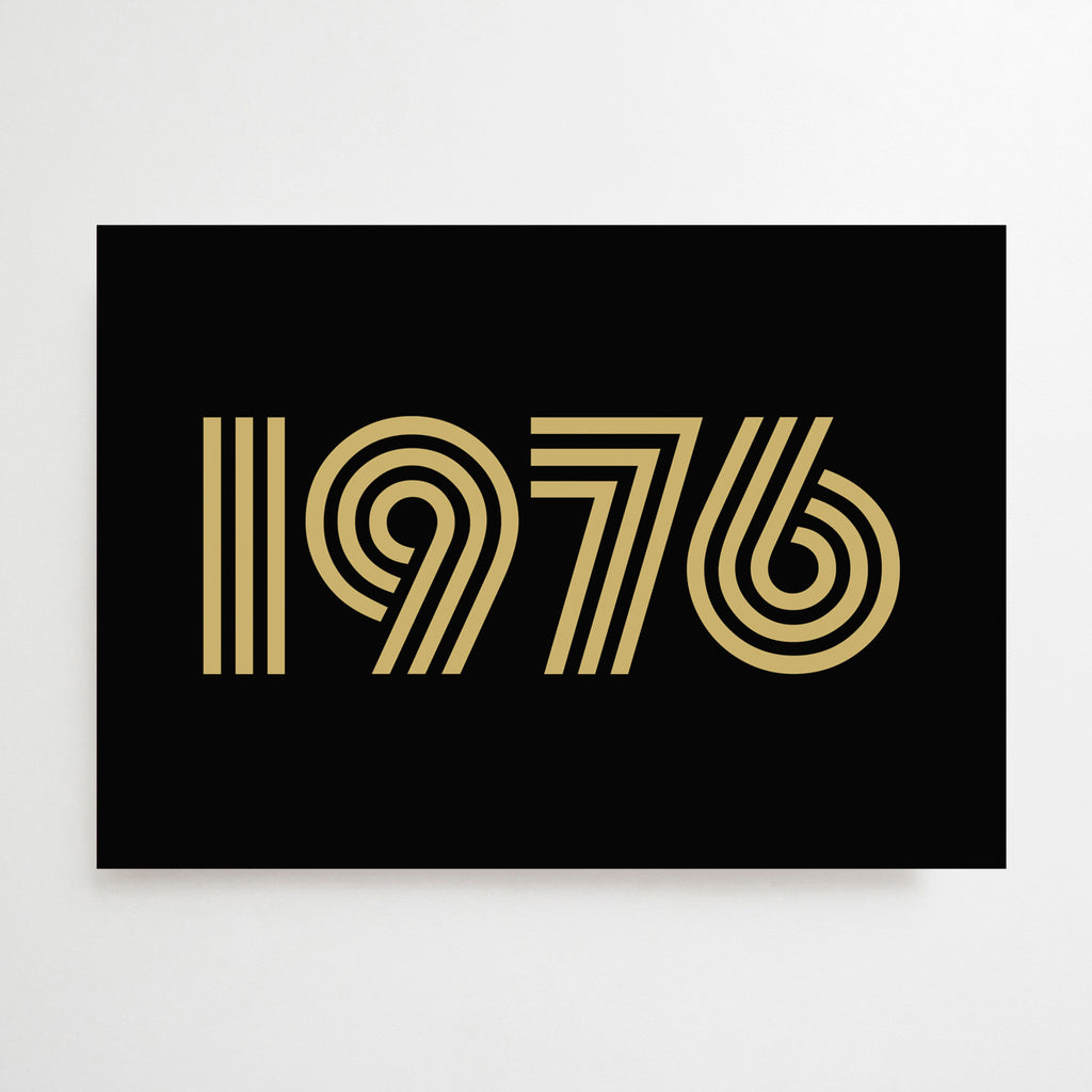 Black greetings card with 1976 printed in gold
