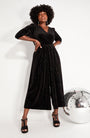Black Rainbow Sparkle Jumpsuit lower viewpoint with heels and disco ball for party season and new year