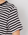 Woman wearing a black and white striped t-shirt against a plain background donna tshirt disko kids