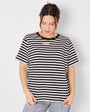 Woman wearing a black and white striped t-shirt against a plain background donna tshirt disko kids
