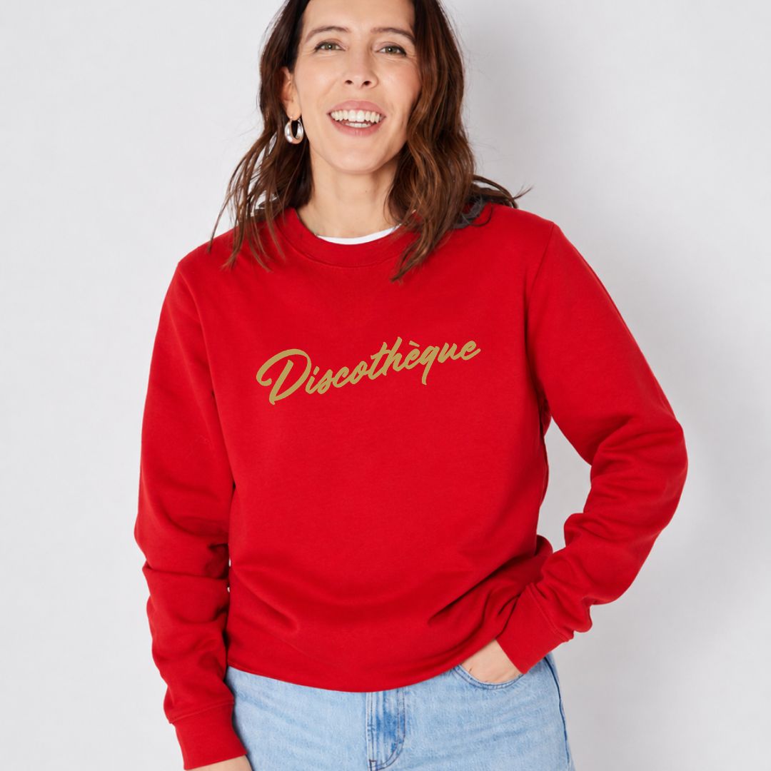 bright red crewneck sweatshirt with 'Discothèque' printed in gold script across the chest,