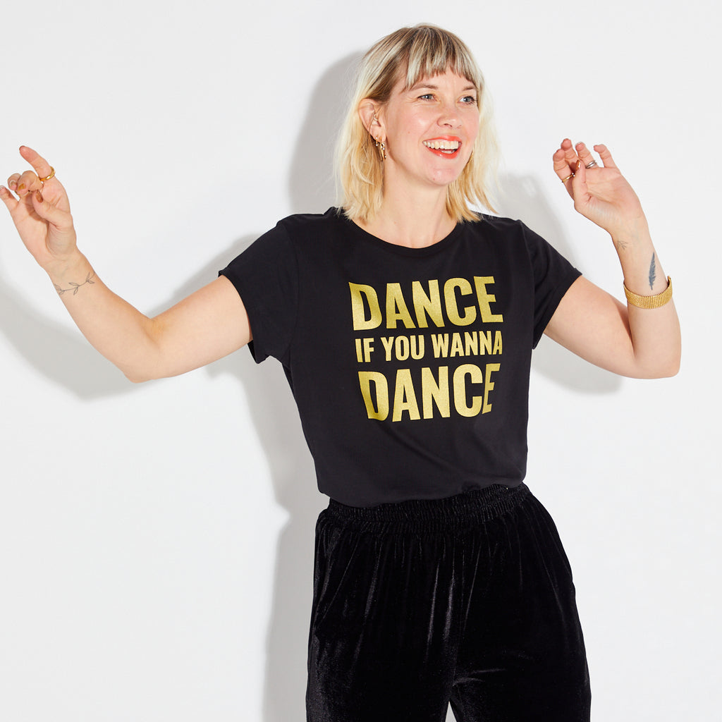 'DANCE IF YOU WANNA DANCE' in gold print on a white background