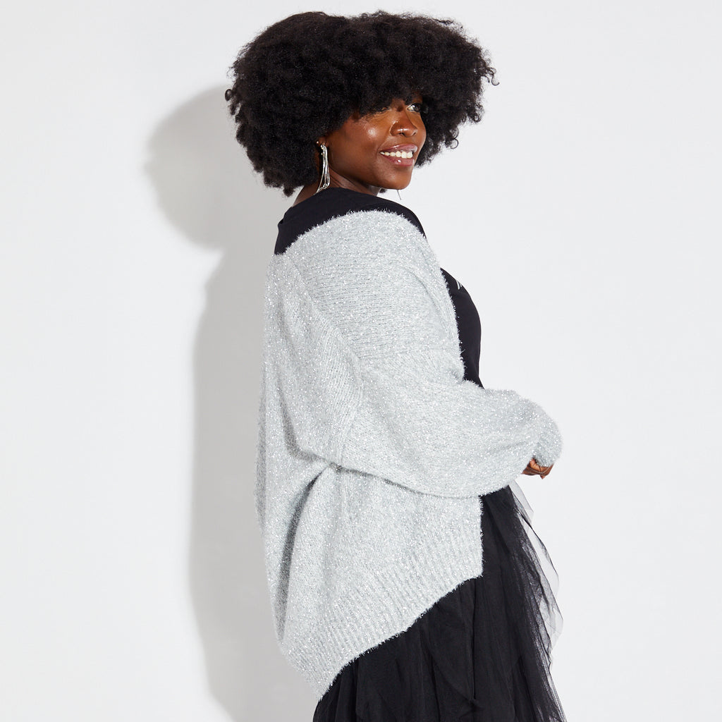Woman wearing silver sparkly cardigan with black disco tshirt