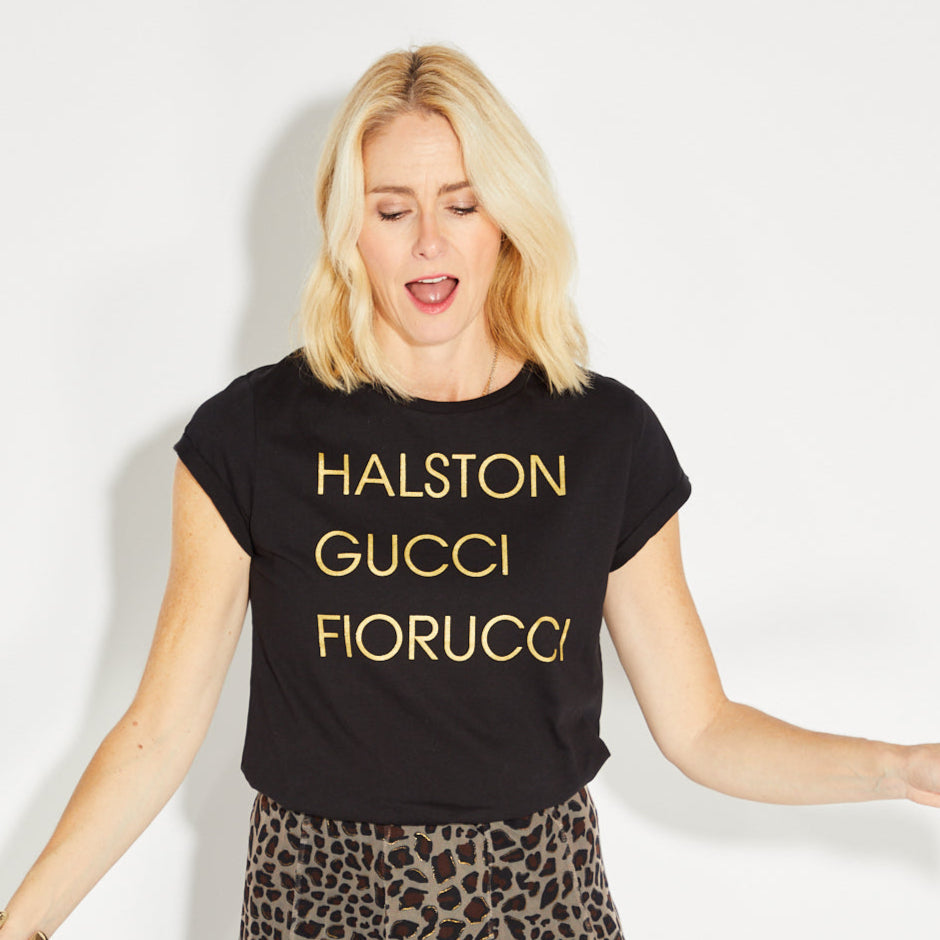 Womens black t-shirt with 'HALSTON GUCCI FIORUCCIO' gold text - Disko Kids