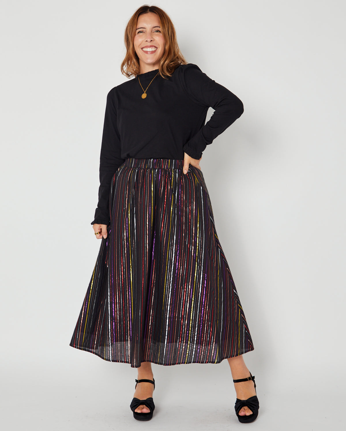 Bonnie Long Sleeve Ruffle Edge Top Black styled with metallic rainbow skirt for party season and christmas
