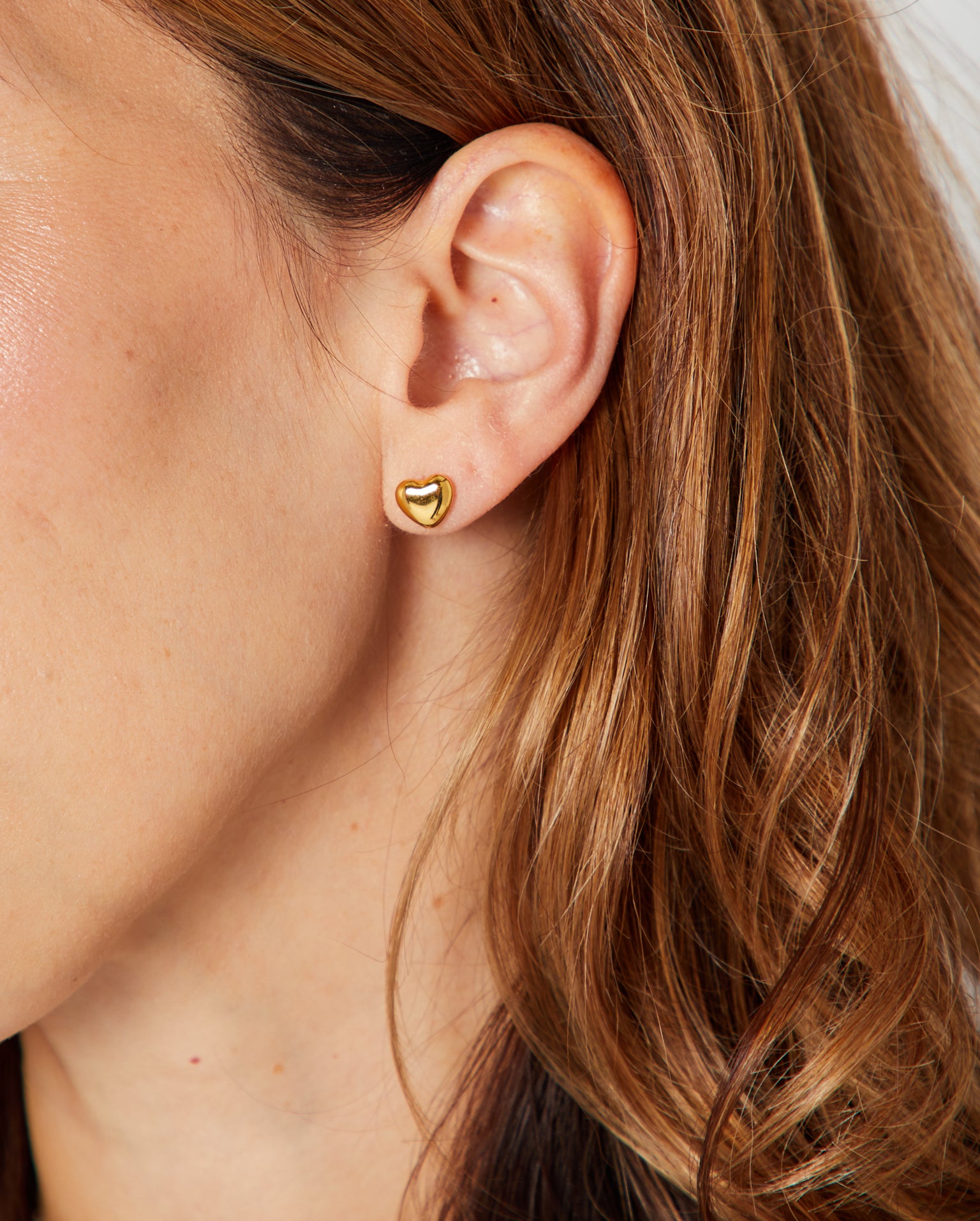 Mini Heart Earrings Gold on person