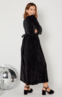 side view of Black Rainbow Sparkle Jumpsuit with heels and showing the tie back waist