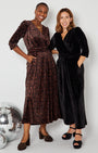 two models in Disko Kids partywear collection jumpsuits one leopard and one black rainbow sparkle