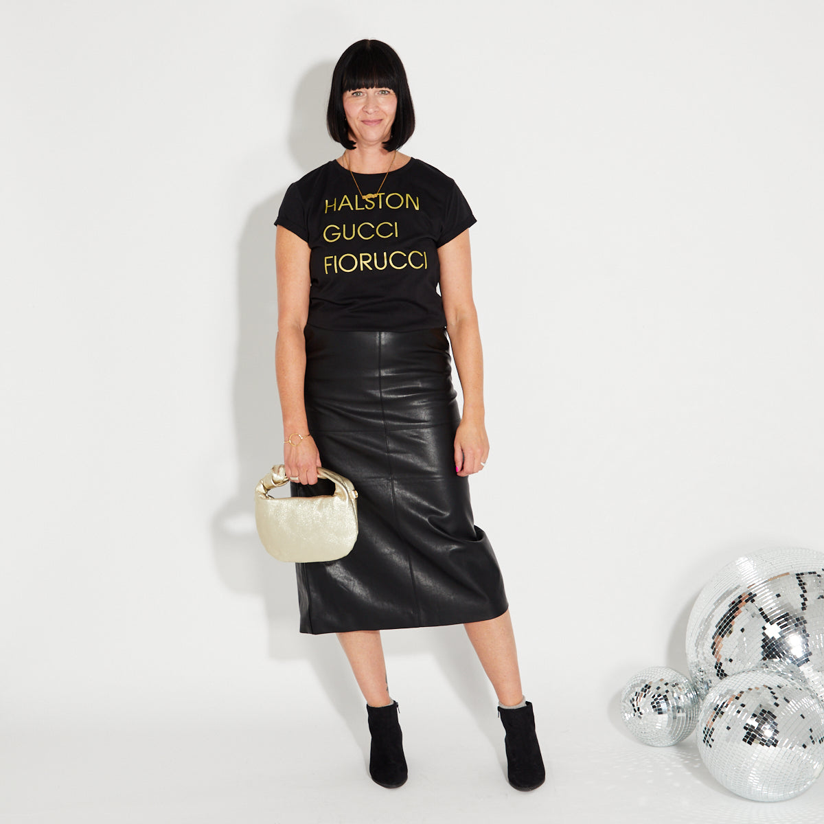 Womens black t-shirt with 'HALSTON GUCCI FIORUCCIO' gold text - Disko Kids