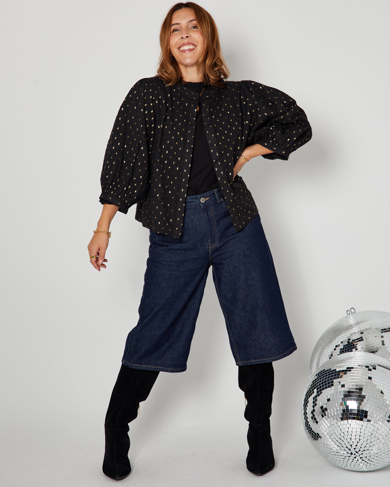 Black & Gold Reversible Jacket styled with jeans and knee high boots full outfit