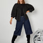 Black & Gold Reversible Jacket styled with jeans and knee high boots full outfit