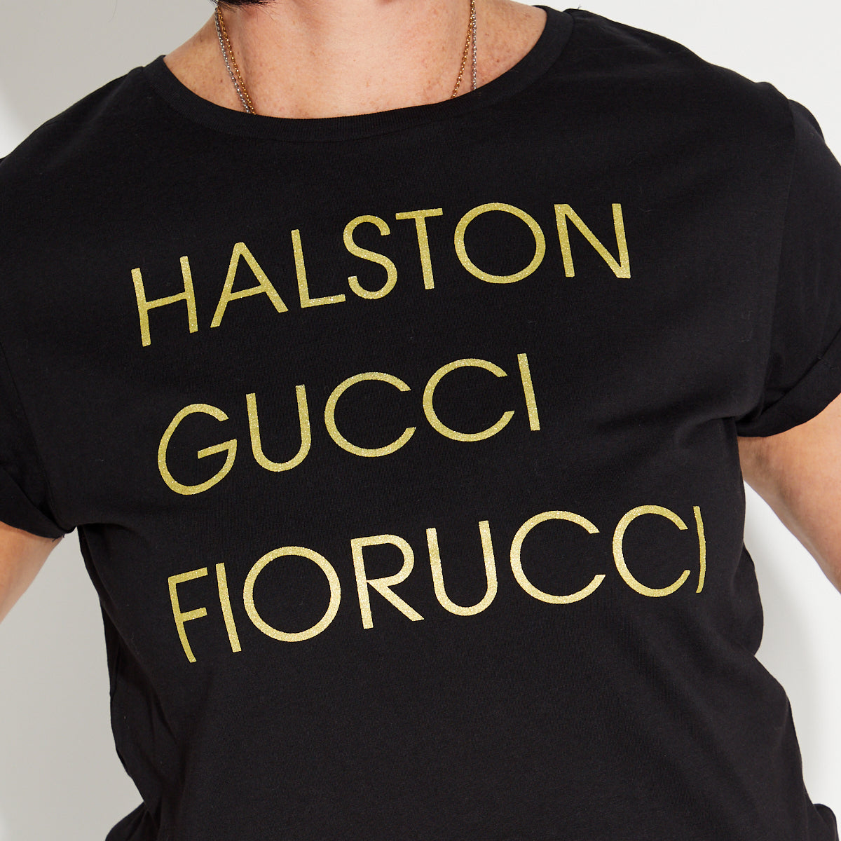 Womens black t-shirt with 'HALSTON GUCCI FIORUCCIO' gold text - Disko Kids