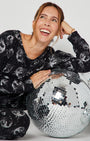Disco Ball Cotton Pyjama Set seated and leaning on disco balls