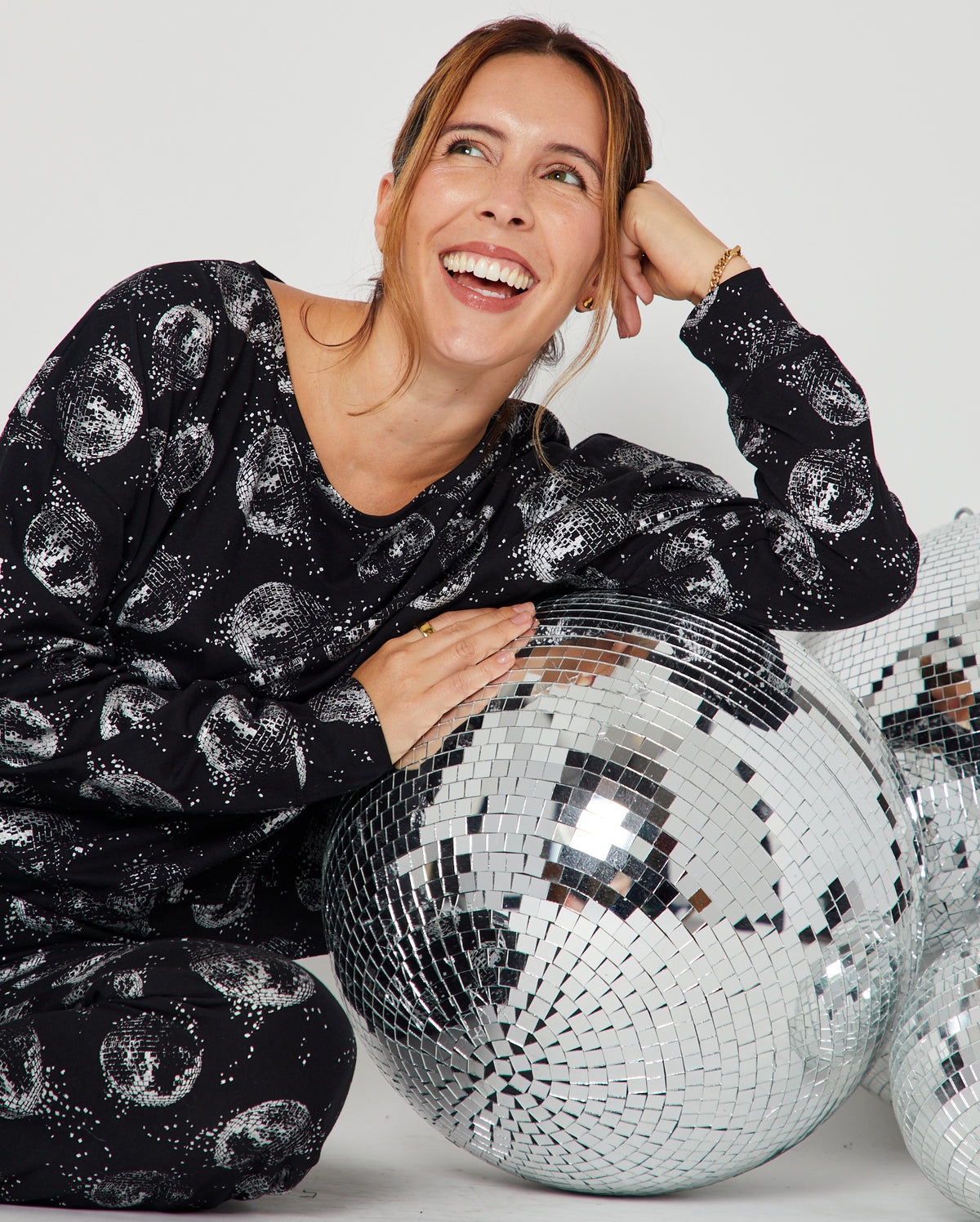 Disco Ball Cotton Pyjama Set seated and leaning on disco balls