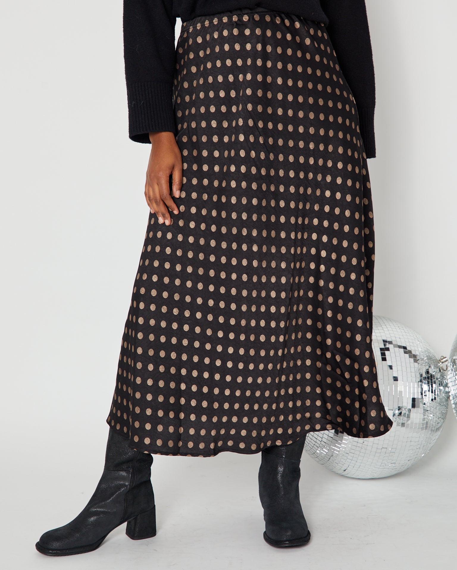 Polka Dot Satin Skirt black and gold close up with boots