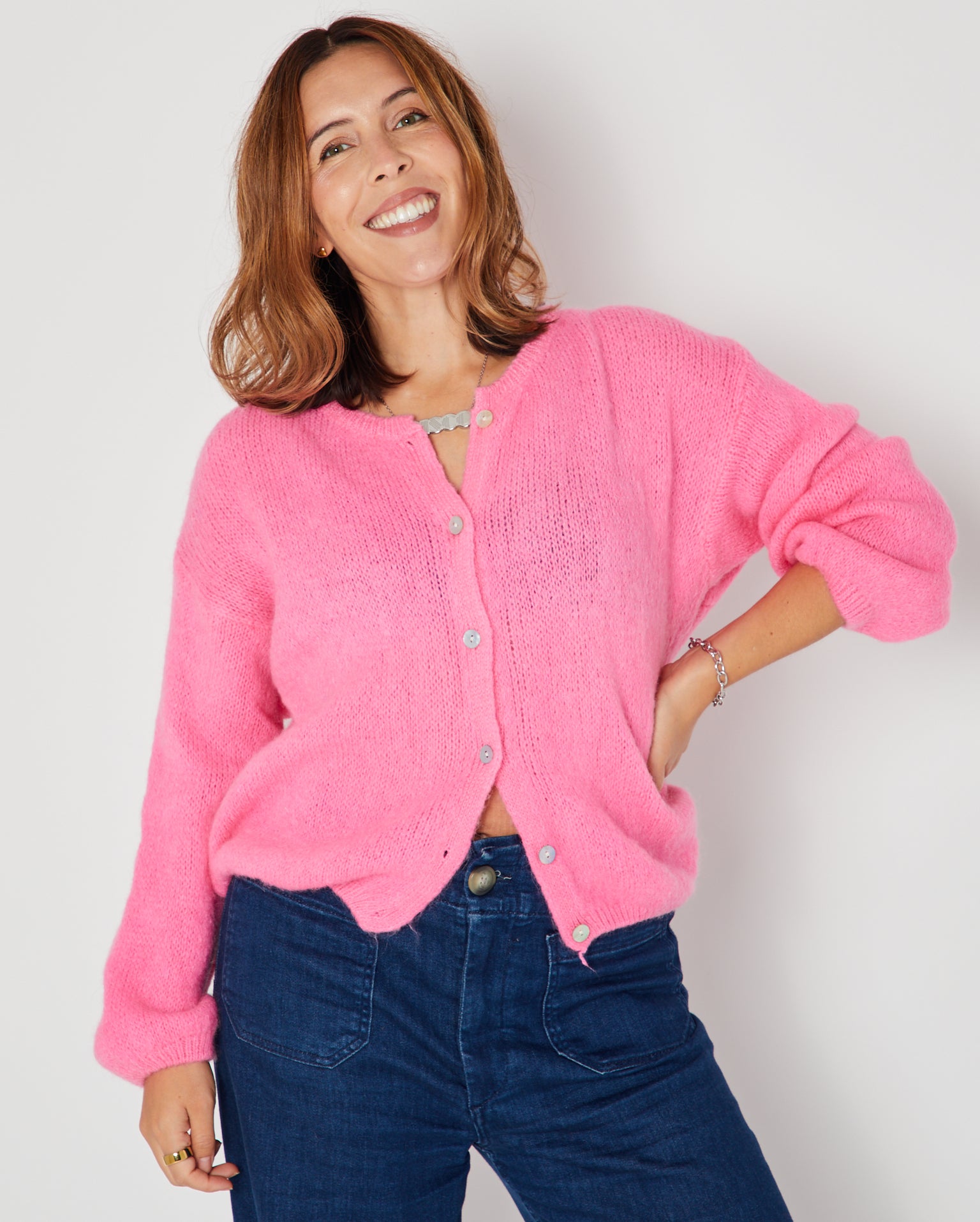 Pink Round Neck Cardigan showing the full cardi with jeans and DISCO necklace