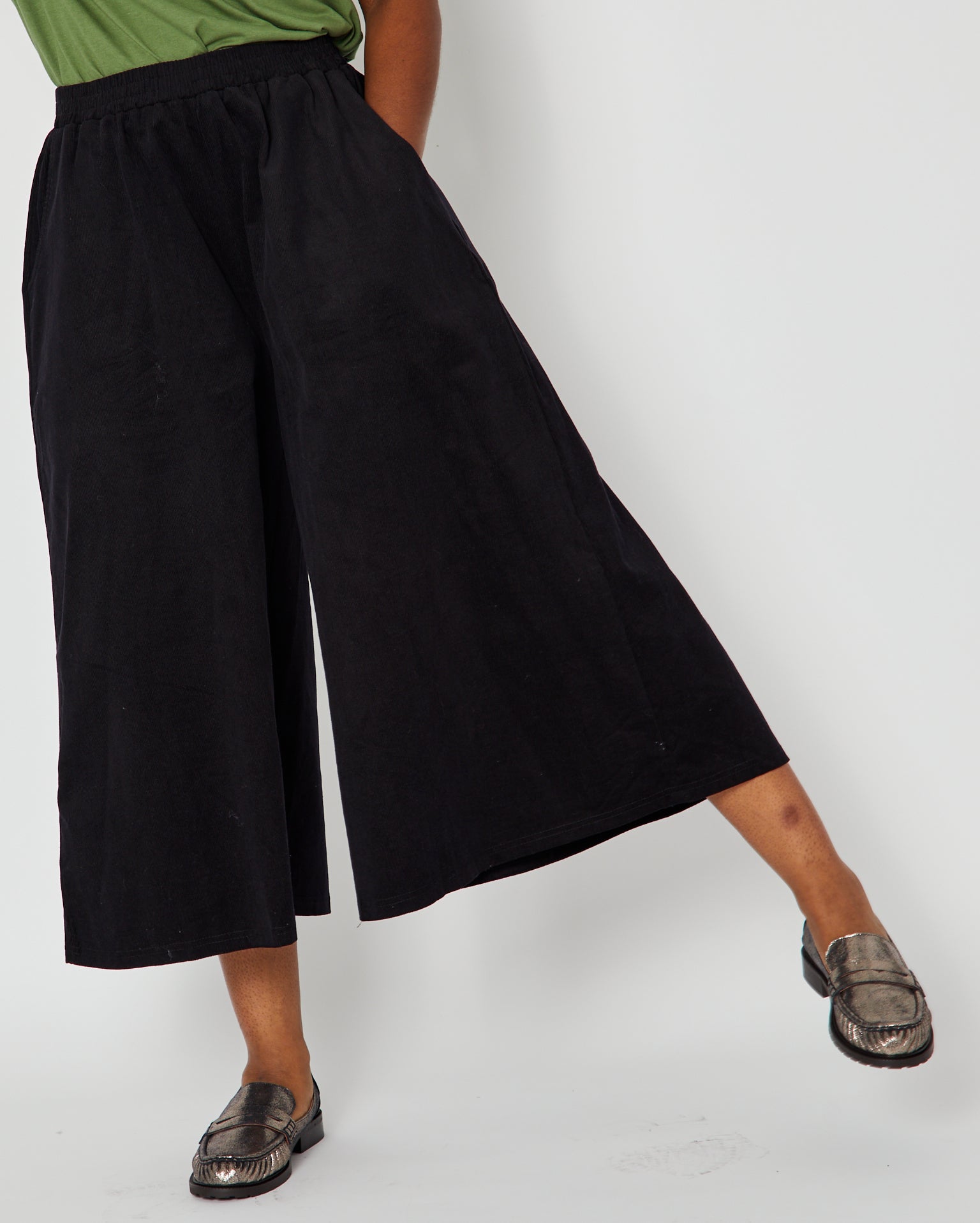 black wide leg culottes in corduroy close up on model