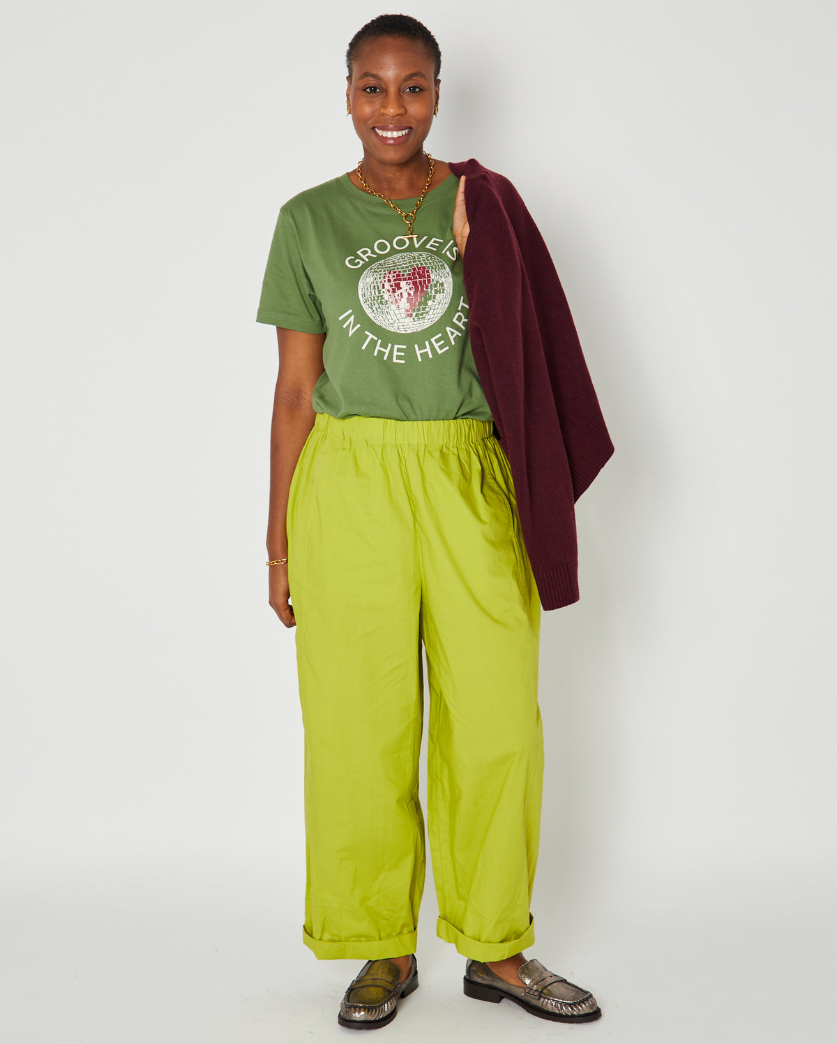 groove is in the heart graphic tshirt full outfit with bright trousers and burgundy knit