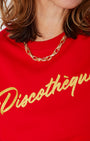 bright red crewneck sweatshirt with 'Discothèque' printed in gold script across the chest,
