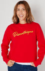 bright red crewneck sweatshirt with 'Discothèque' printed in gold script across the chest,