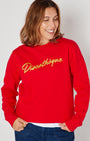 bright red crewneck sweatshirt with 'Discothèque' printed in gold script across the chest,
