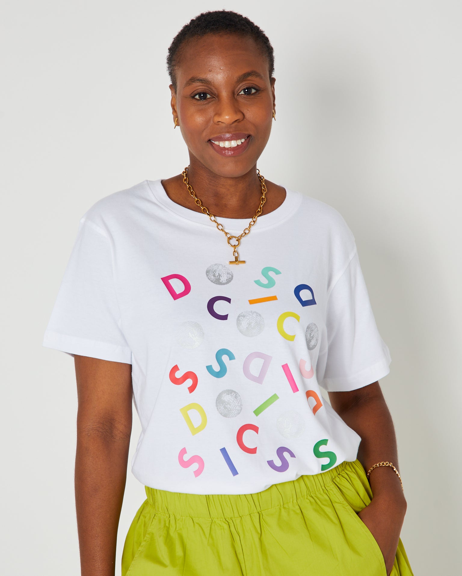 Disco Confetti Donna Tshirt White styled with bright trousers and Tbar necklace