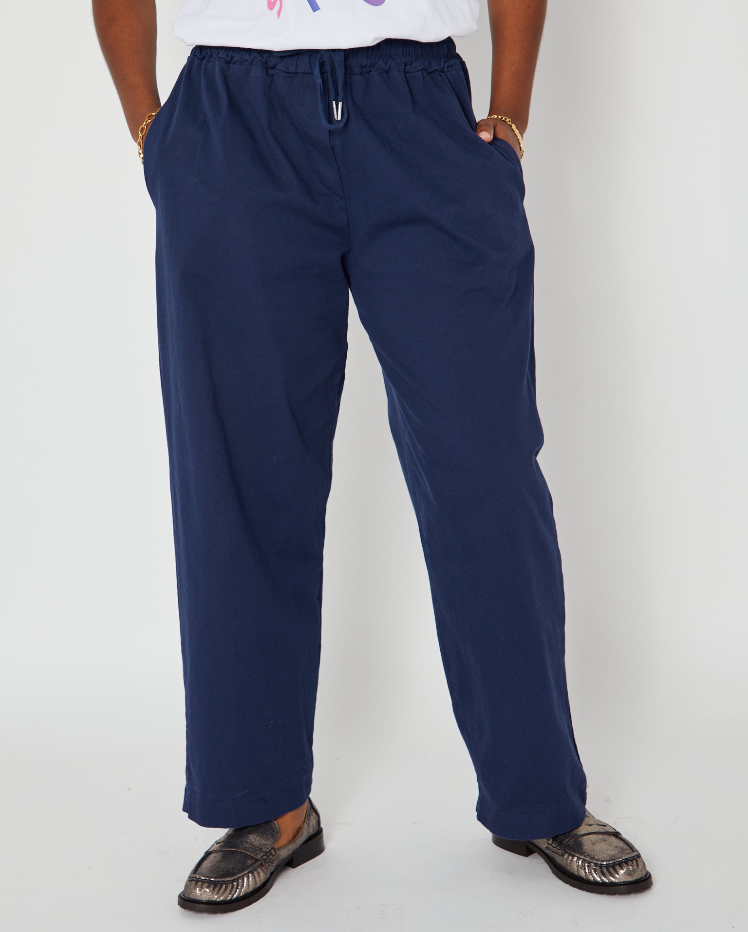 navy barrel leg drawstring trousers close up