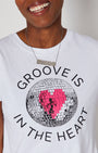Groove Is In The Heart disco ball graphic tshirt close up with DISCO silver pendant