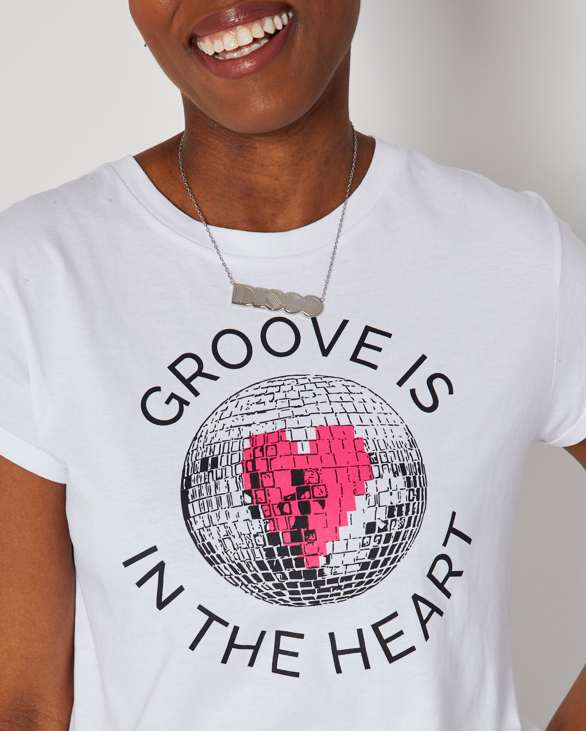 Groove Is In The Heart disco ball graphic tshirt close up with DISCO silver pendant