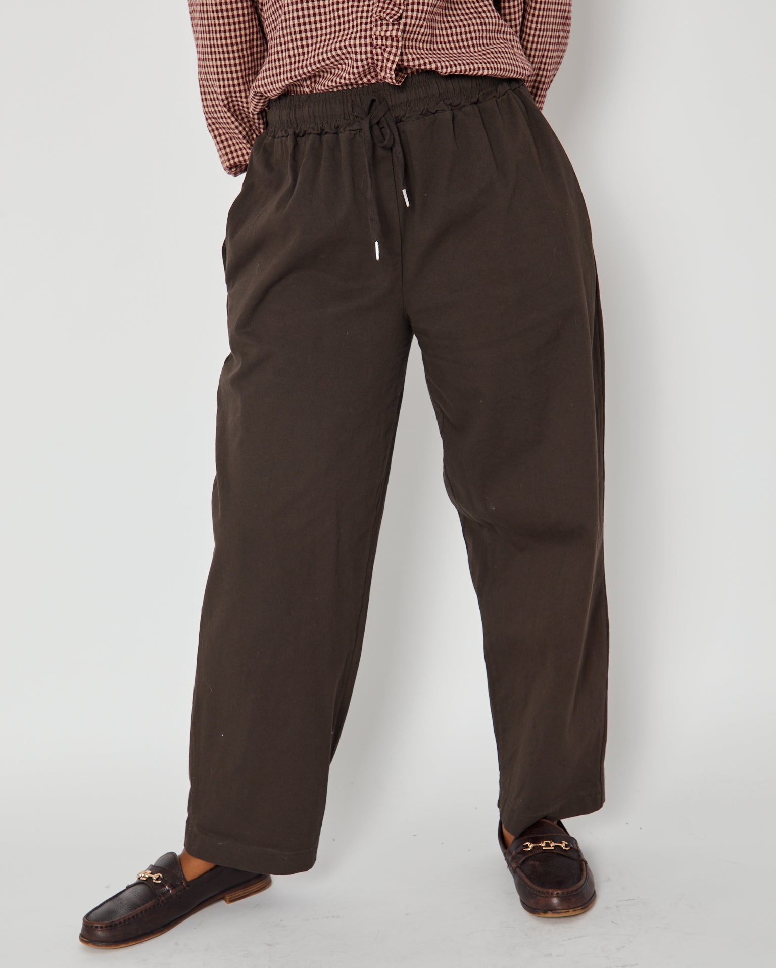 brown barrel leg trousers close up with loafers and drawstrings