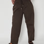 brown barrel leg trousers close up with loafers and drawstrings