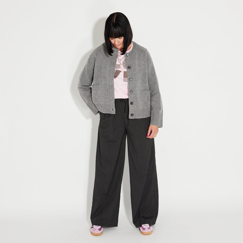 Dark Grey Striped Wide Leg Trousers with grey knit jacket and pink LOVE IS tshirt