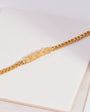 Gold chain DISCO bracelet on a white surface