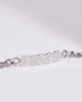 Silver chain bracelet with 'DISCO' engraved on a light gray background