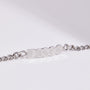 Silver chain bracelet with 'DISCO' engraved on a light gray background
