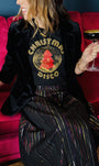 woman in a metallic rainbow skirt and gold metallic and red christmas disco tshirt black 