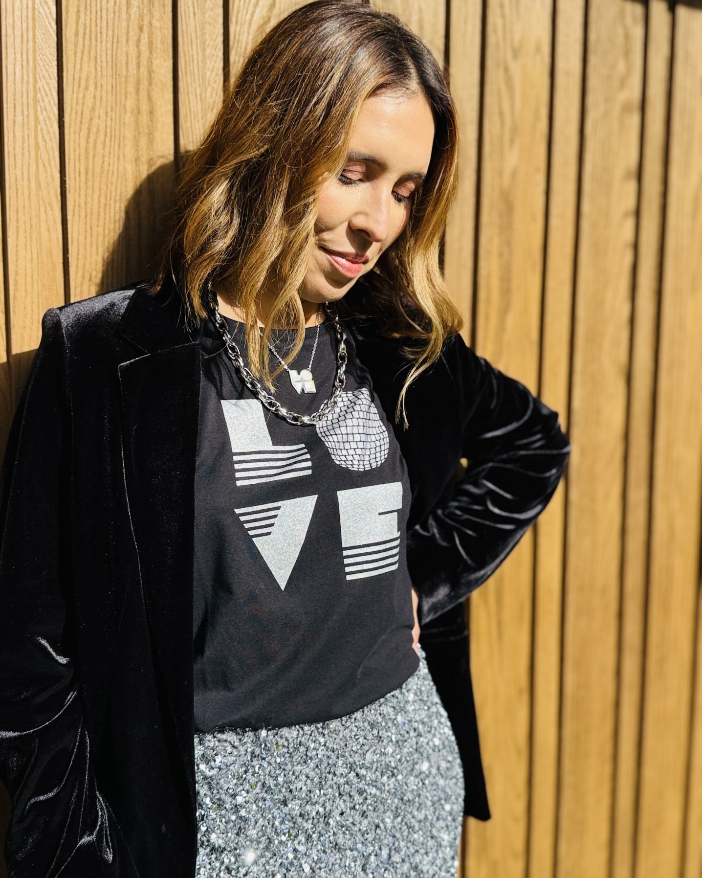 black rolled sleeve tshirt with love graphic and silver sequin pencil skirt