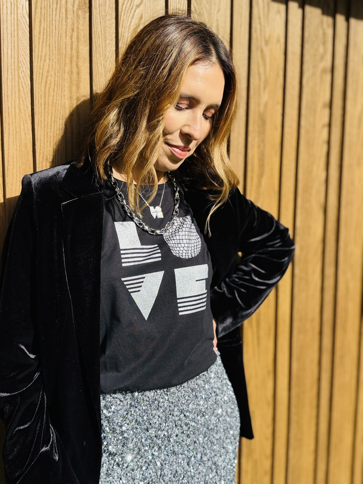 black rolled sleeve tshirt with love graphic and silver sequin pencil skirt
