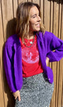 red tshirt with disco ball and a purple cardigan and silver skirt Christmas partywear