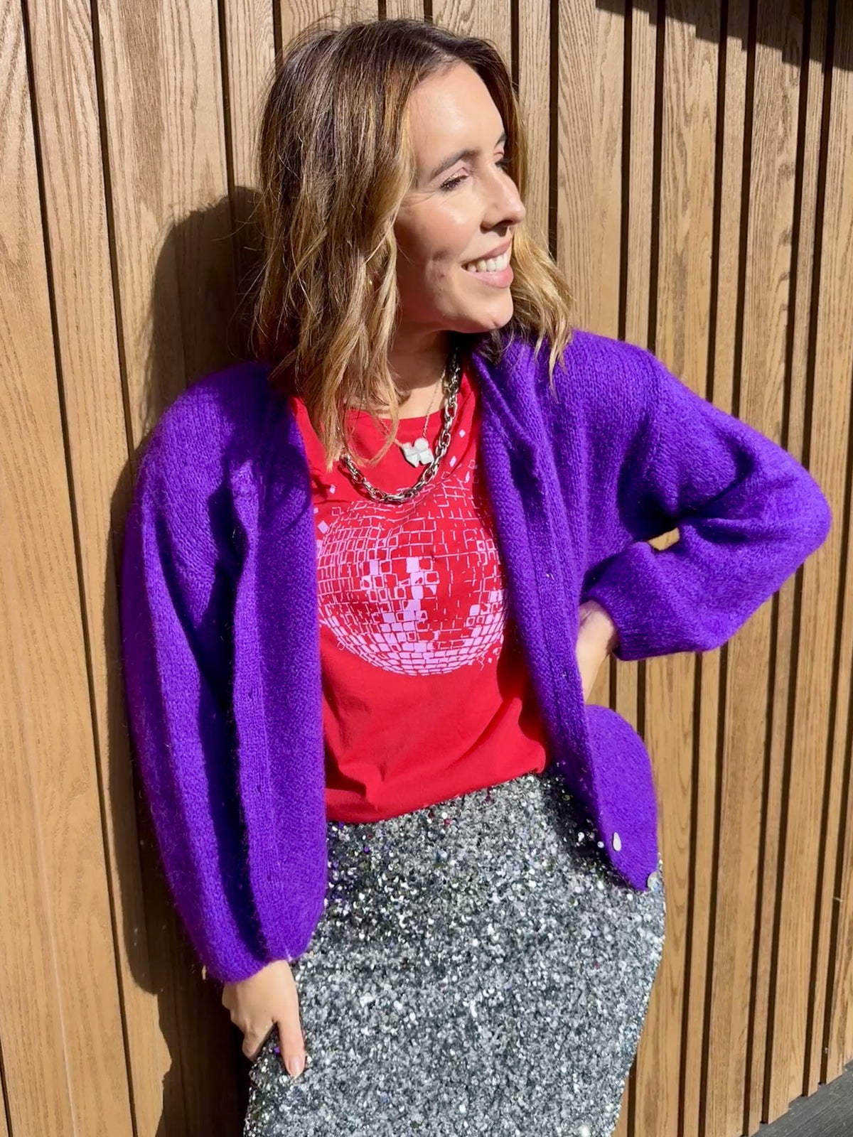 red tshirt with disco ball and a purple cardigan and silver skirt Christmas partywear