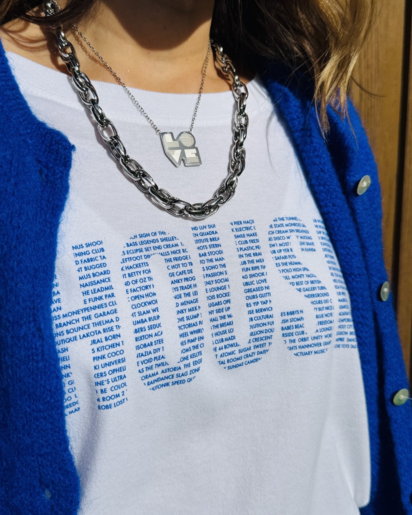 white tshirt with house and 90's clubs close up