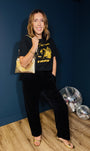 girl put your records on black tshirt with gold metallic bag