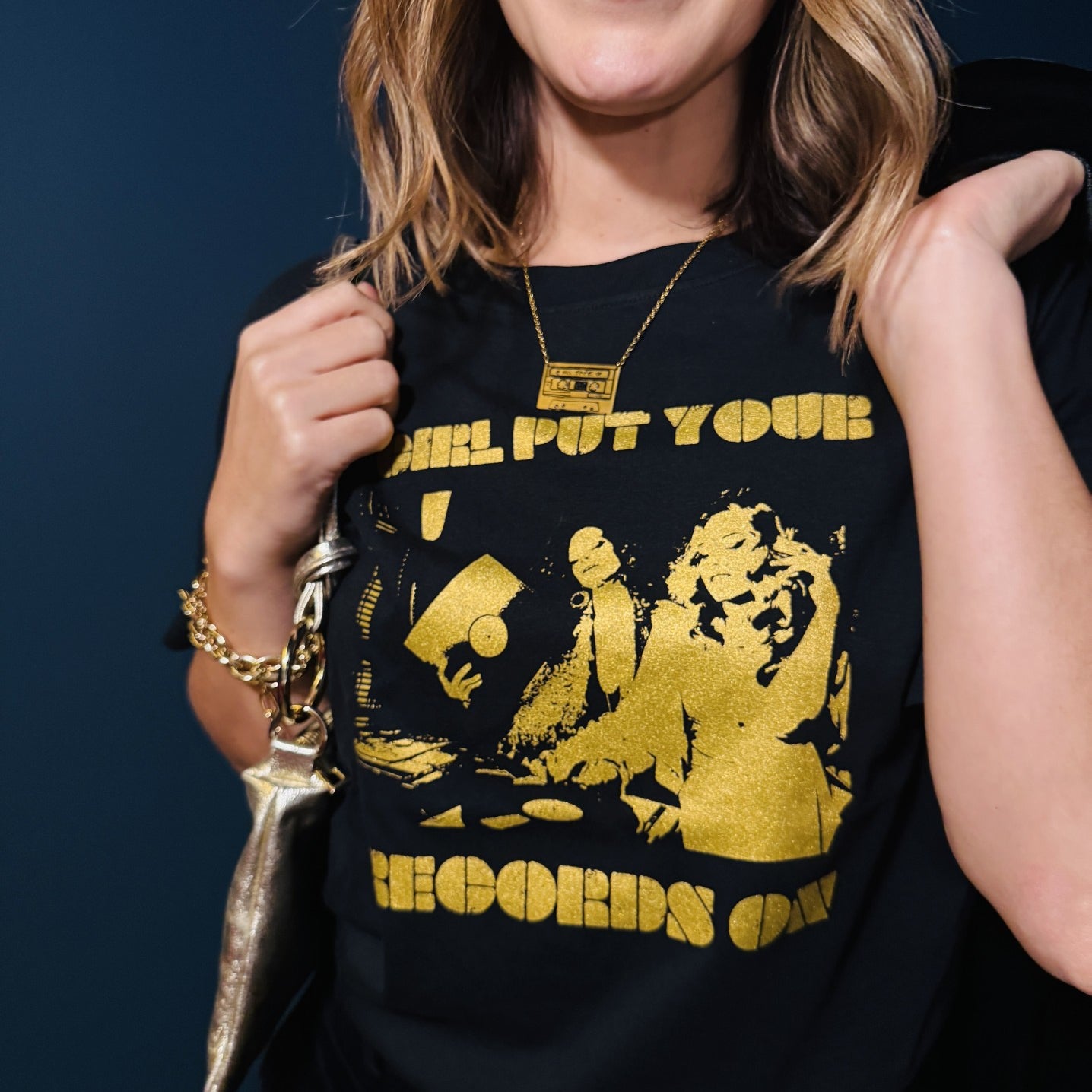 Close up of girl put your records on black tshirt and mixtape pendant