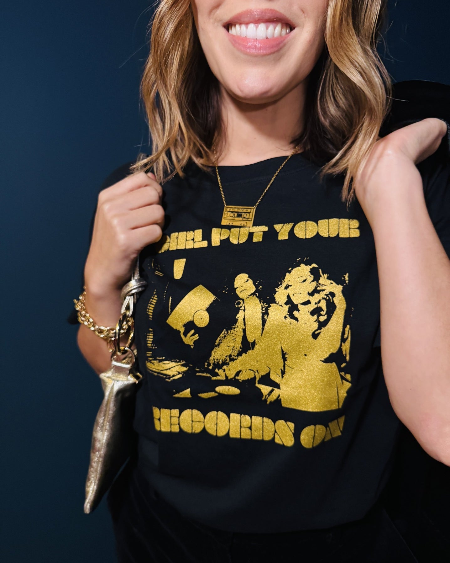 Close up of girl put your records on black tshirt and mixtape pendant