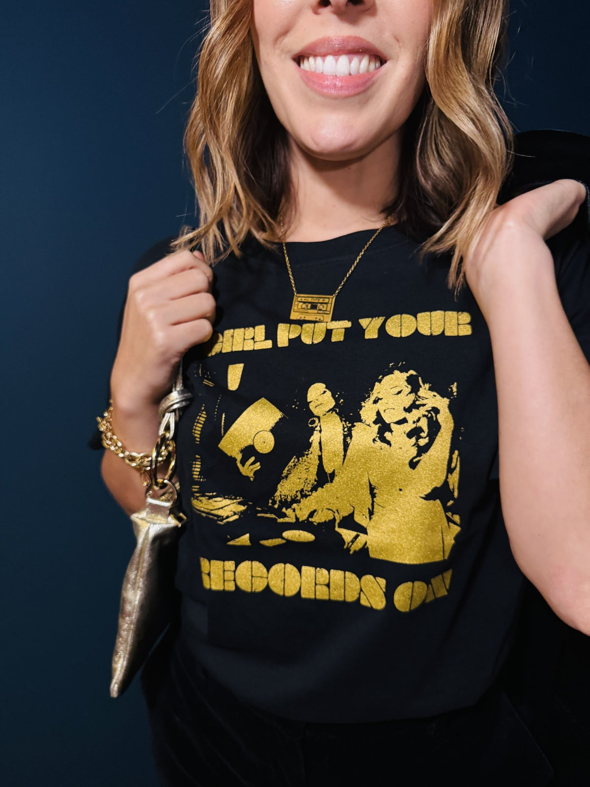 Close up of girl put your records on black tshirt and mixtape pendant