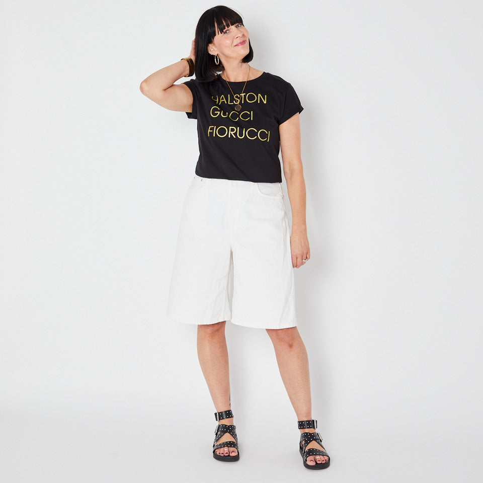 Womens black t-shirt with 'HALSTON GUCCI FIORUCCIO' gold text - Disko Kids